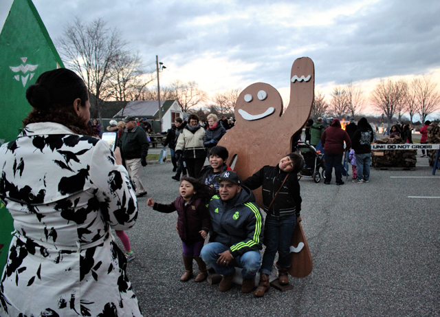 The Maldonado family posing for a photo with gingerbread man cutout (taking photo: Christina Maldonado, posing: Jairon and children Julianna, Llayron, and Victoria) (Credit: Elizabeth Wagner)