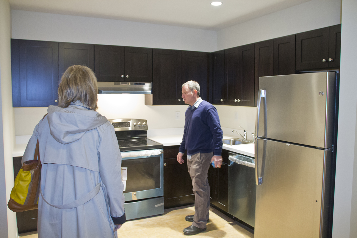 Developer Michael Butler leads Pat Snyder, the East End Arts director, on a tour of the building during an open house Wendesday night. (Credit: Paul Squire)