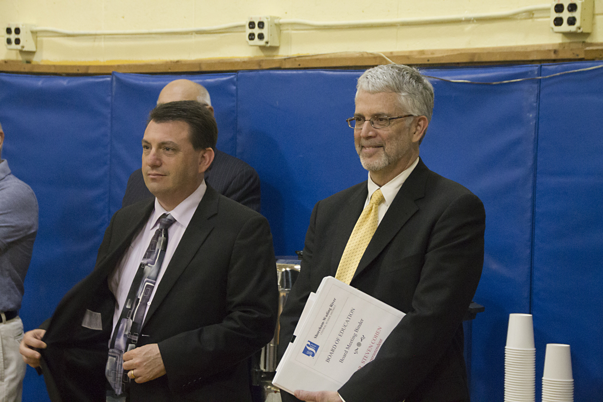 Superintedent Steven Cohen (right) smiles as the results from Tuesday's school budget vote are read aloud. (Credit: Paul Squire)