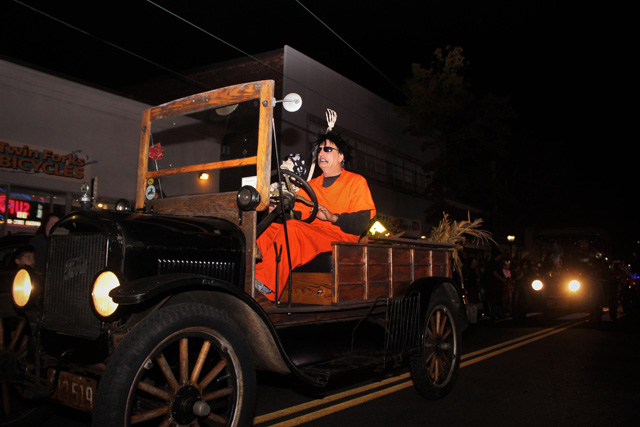 An escaped convict and his skeleton accomplice driving their escape vehicle - a classic Ford.