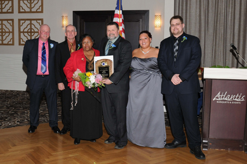 (Courtesy photo) Lifetime achievement award winner Betty Harris (third from left) accepts her award with Corps board members Ron Rowe, Keith Lewin, Bruce Talmage and Kim Pokorney and Chief Joseph Oliver at the corps' dinner Saturday night.