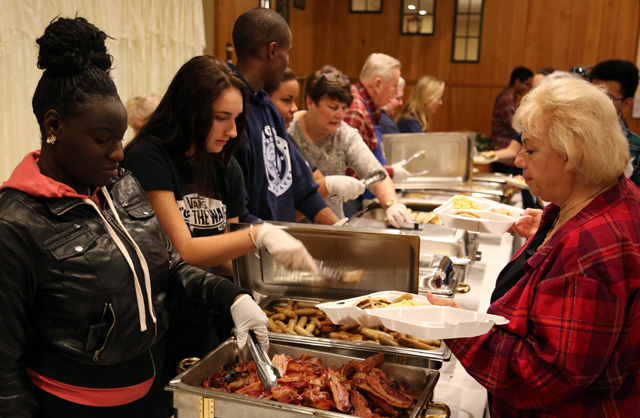 Riverhead High School students Jalisa Armstrong of the Community Service program and Nicole Tarasiuk of Interact serve breakfast.
