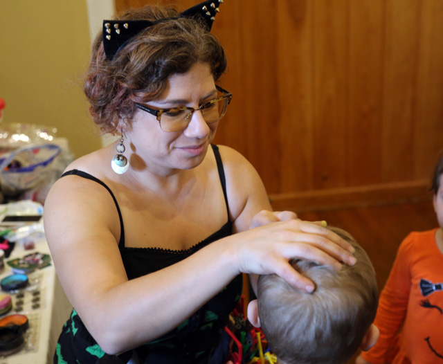 Shelley Wapniak of Body Art by Shelley Wapniak paints the face of a youngster. She also made dozens of kids balloon animals during the event.
