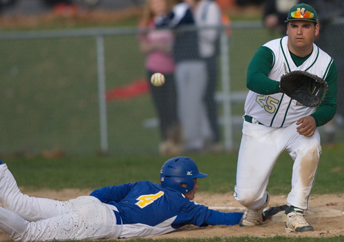 GARRET MEADE PHOTO | Mattituck's Will Gildersleeve diving safely back to first base while Bishop McGann-Mercy's Christian Lynch awaited the attempted pickoff throw.