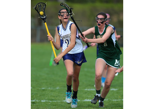 Bishop McGann-Mercy's Monica Healy defends against Mattituck/Greenport/Southold's Rileyb Hoeg, who prepares to take a shot. (Credit: Daniel De Mato)