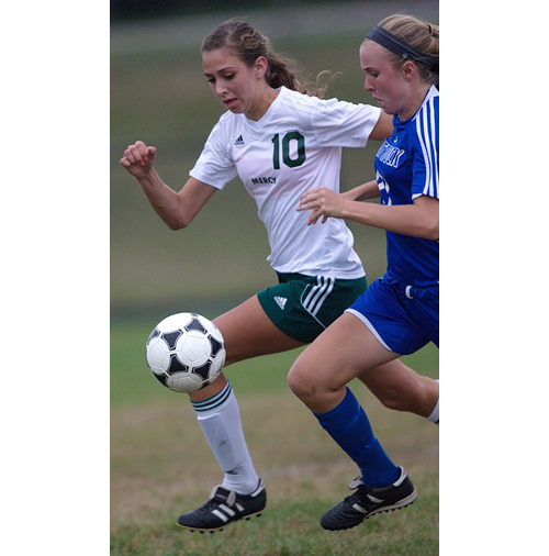 Bishop McGann-Mercy's Dayna Young (10) and Mattituck's Alex Beebe running neck and neck for a ball. (Credit: Garret Meade)