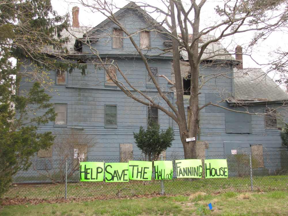 Supporters of the Hallock Fanning house on Flanders Road recently placed these signs on the property. (Credit: Tim Gannon)