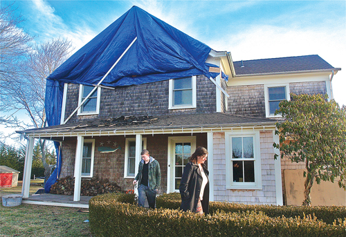 BARBARAELLEN KOCH PHOTOTristin Krueger and his mother, Raven, in front of their fire-damaged home on Twomey Avenue in Calverton. (Barbaraellen Koch file photo)