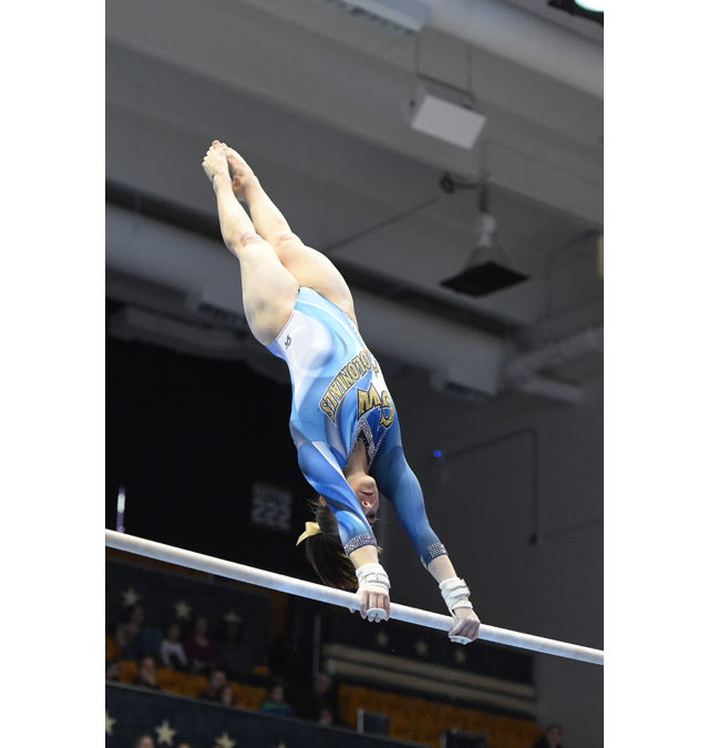 Cami Drouin-Allaire competes in the bars. (Credit: GW Athletics Communications)