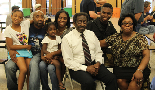 Retiring Pulaski Street School head custodian Carl James, front, with his family at a June 24 school board meeting. (Credit: Jennifer Gustavson photos)