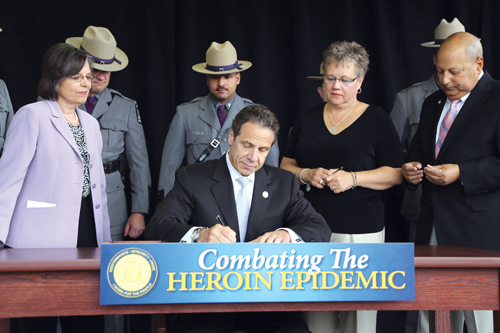 Gov. Andrew Cuomo signs legislation on Monday at the University of Binghampton related to tightening controls on heroin. (Credit: Office of Gov.