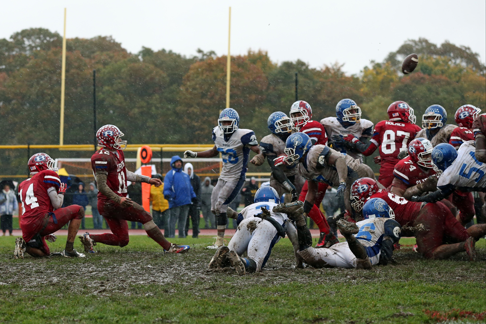 Bellport's Nick Founts has his last-second field goal attempt blocked by Troy Trent (77). (Credit: Daniel De Mato)