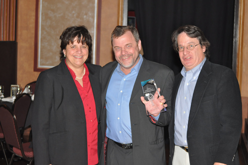GRANT PARPAN PHOTO | Denise Civiletti and Peter Blasl of Riverhead Local with award presenter Tom Lennon.