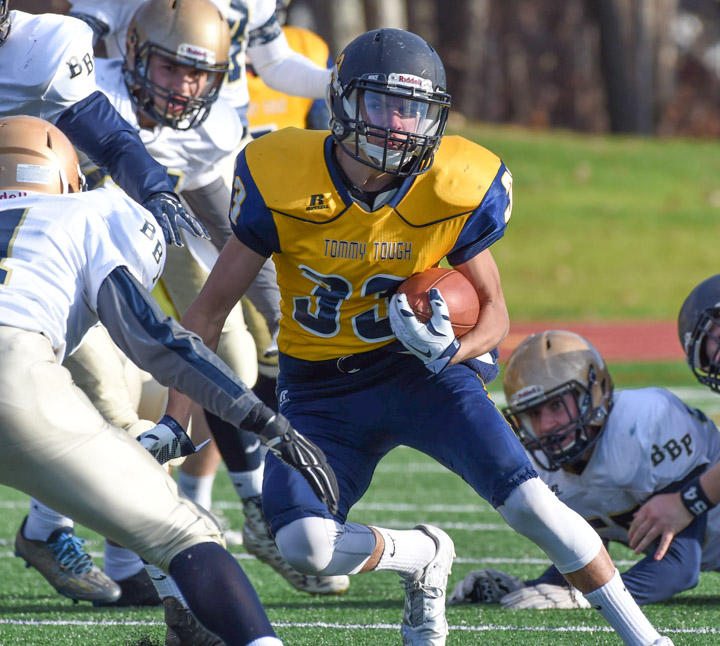 Jon Constant looks for an opening as several Bayport-Blue Point players get set to tackle him.