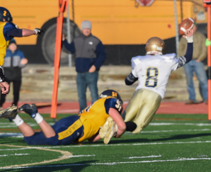 Dalten Stalzer records a sack on Bayport-Blue Point quarterback Robert Johnson as he throws the ball away. Intentional grounding was called on the play.