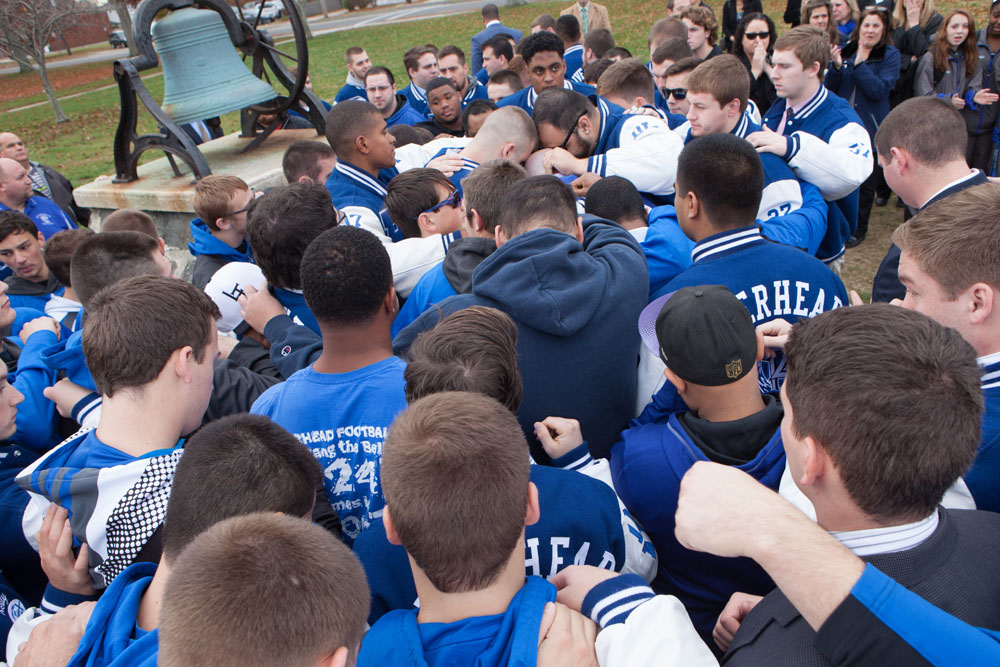 The former players all gathered for a team embrace after the DeCabia brothers rang the victory bell. (Credit: Katharine Schroeder)