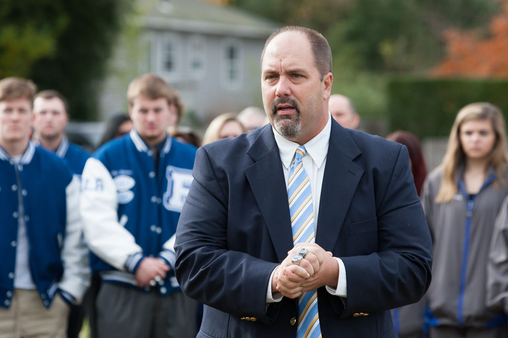 Riverhead football coach Leif Shay shares a few words with those in attendance for the ceremony at the bell. (Credit: Katharine Schroeder)