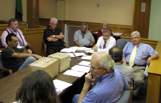Deputy Town Attorney Dan McCormick, center, explains the BID bylaws on elections to BID management association members Wednesday night. (Credit: Tim Gannon)
