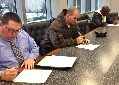 GIANNA VOLPE FILE PHOTO | Applicants fill out paperwork at a job fair held at the County Center in Riverhead.