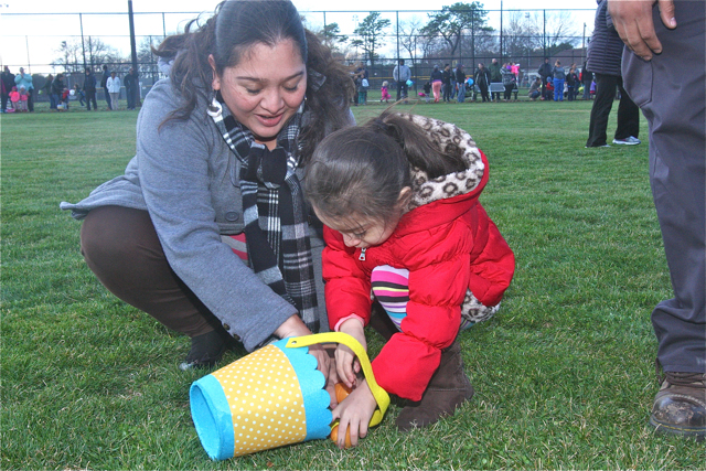 Nassyeli Maldonado and her daughter Giselle, 4, of Riverhead gather eggs. (Credit: Barbaraellen Koch)