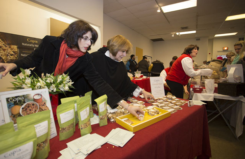 KATHARINE SCHROEDER PHOTO | Lucy Cascio, left, and Grace Longinetti rush to restock their samples at Copia Granola's booth.