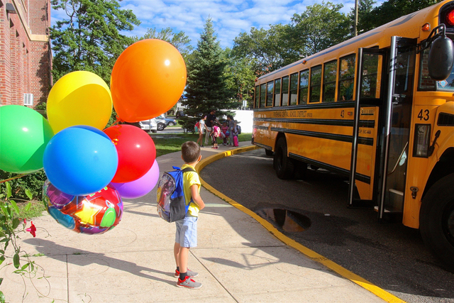 Kindergartner Edward Stackevicius waits for other students to get off the bus.