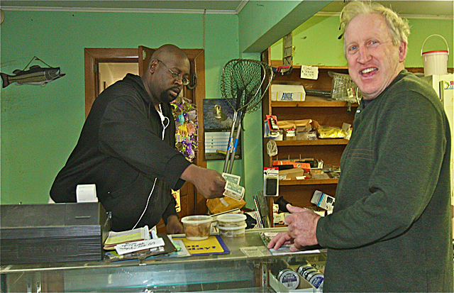 Fishermans Deli worker Roger Miles sells some bait to longtime customer Mike O'Donnell of Calverton Thursday morning. (Credit: Barbaraellen Koch)