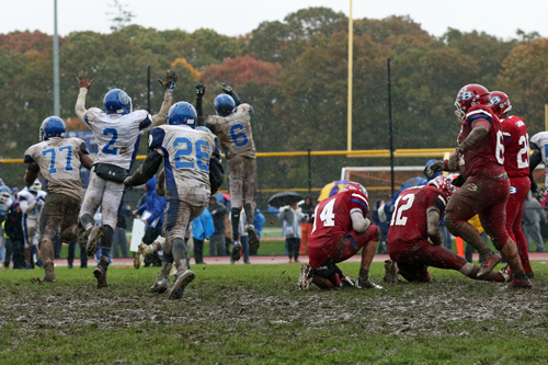 Riverhead celebrates after Bellport's Nick Founts (#12) has his last second field goal attempt blocked by Troy Trent (#77.) (Credit: Daniel DeMato)