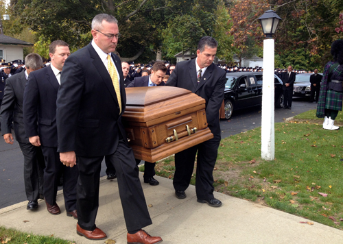 RACHEL YOUNG PHOTO | Riverhead Police officer Benjamin Goodale's casket is carried into the Old Steeple Community Church in Aquebogue Saturday.