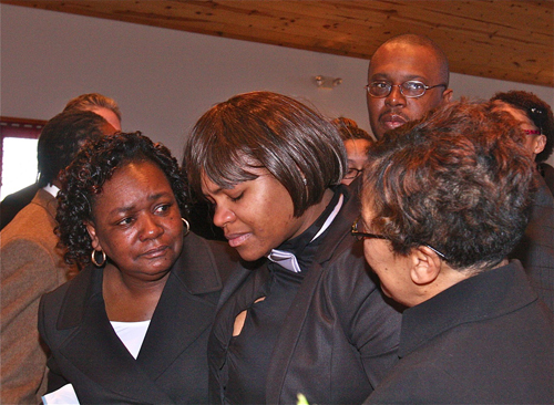 BARBARAELLEN KOCH PHOTO | Demitri Hampton's cousin Latisha Diego (center) is helped by other mourners as she goes up to view the casket for the final time before it is closed.