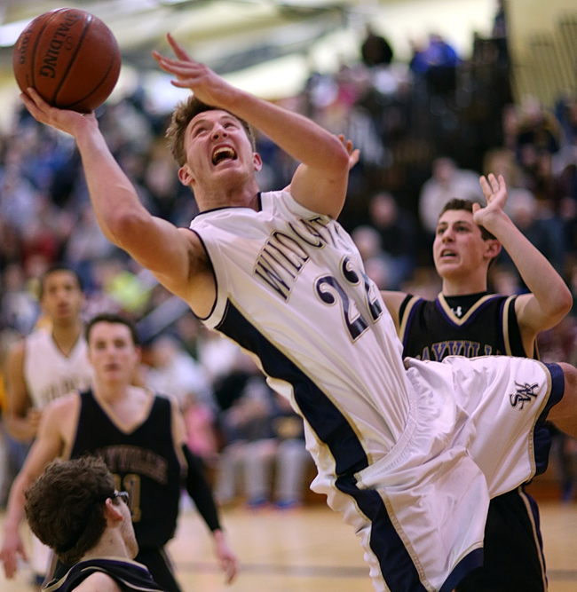 Shoreham-Wading River senior Danny Hughes goes up for a shot Tuesday against Sayville. (Credit: Garret Meade)