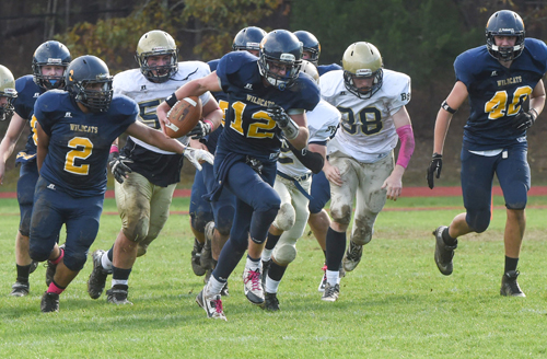 Shoreham-Wading River quarterback Daniel Hughes carries the ball against Bayport-Blue Point last weekend. (Credit: Robert O'Rourk)