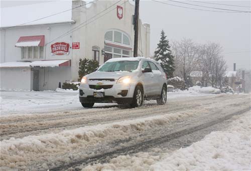 BARBARAELLEN KOCH PHOTO | The street in front of Polish Hall was heavily rutted with the slushy icy snow just after 8 a.m. today.