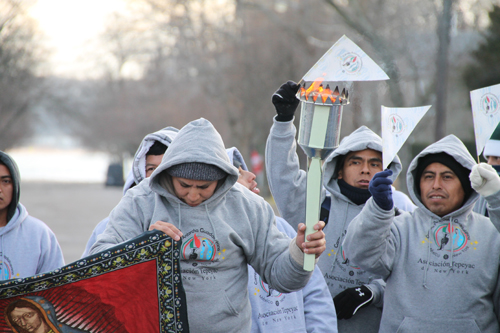 PAUL SQUIRE PHOTO | More than 40 worshippers ran from Greenport to Riverhead Thursday afternoon to deliver a holy flame honoring Our Lady of Guadalupe, a popular religious symbol.