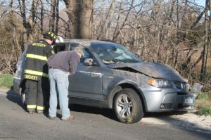 PAUL SQUIRE PHOTO | The woman driving in this BMW was not seriously injured when it flipped over, authorities said.