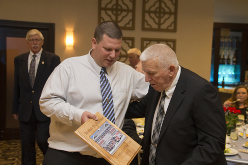 Second lieutenant of the year Brian Raynor hands the company of the year award to Charles Bloss, a longtime member of the department. (Credit: Paul Squire)