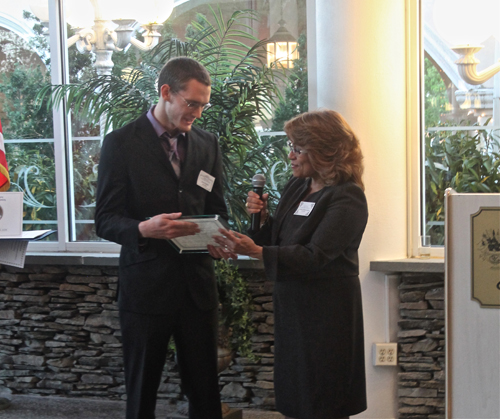 PAUL SQUIRE PHOTO | Jesse Hopkins receives his award from the Suffolk County HUman Rights Commission Thursday night.