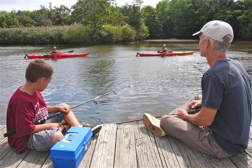 Liam Hansen of Wading River fishes with his father Mark on the town's floating dock during the 15th annual Riverhead Snapper Tournament in 2012. (Credit: Barbaraellen Koch, file)
