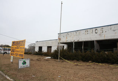 IMG_6259 BARBARAELLEN KOCH FILE PHOTO | The Rolle Brothers building that fronted Route 58 in Riverhead just days before it was torn down in February 2010.