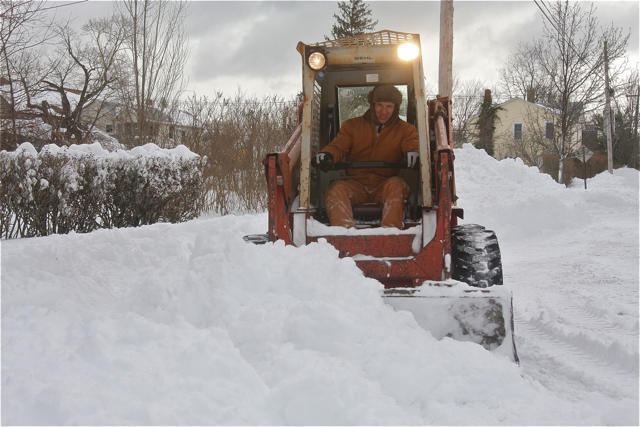 Greg Szlejter clearing large drifts in front of a friend's house on Swezey Avenue. (Credit: Barbaraellen Koch)