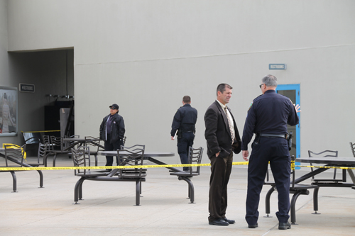 PAUL SQUIRE PHOTO | Riverhead police officers investigate where a woman was allegedly attacked at Tanger Outlet Center.