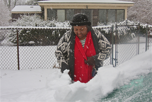 BARBARAELLEN KOCH PHOTO | Betty Harris cleans off her car parked in front of her home on Hamilton Avenue in Polish Town. She said she had the day off of work but wanted toe move the car into her driveway so it wouldn't get plowed in when the plows make their rounds.