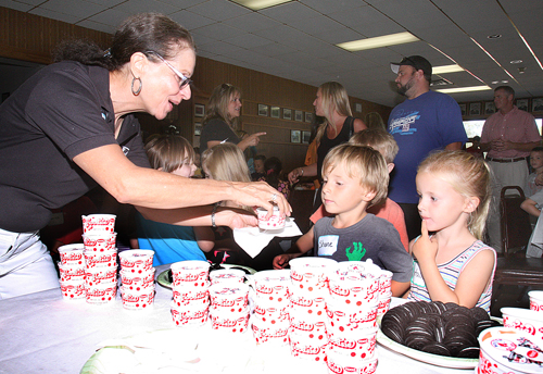 Riverhead teacher Shirley Hill in Jamesport BARBARAELLEN KOCH PHOTO | Riverhead teacher Shirley Hill giving out ice cream to kindergartners Wednesday at the Jamesport firehouse.