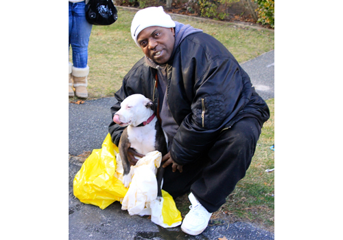 JENNIFER GUSTAVSON PHOTO | Joe Coffey with his dog that was rescued from the fire.
