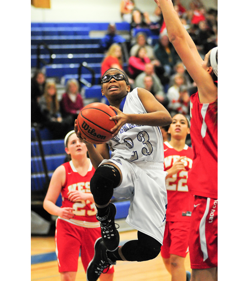 Riverhead guard Faith Johnson-DeSilvia drives to the basket Thursday against Hills West. (Credit: Bill Landon)