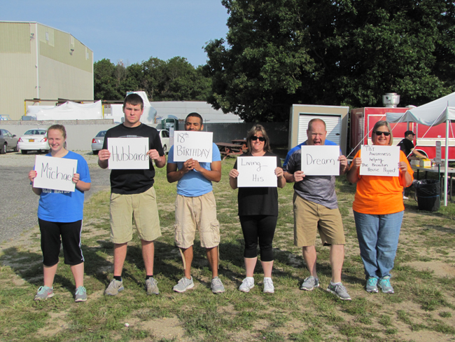 The jumpers, from left, Rebecca Van Houten, Michael Curtis, Kris Smalls, Kathleen Shea, Jerry Halpin and Jude Losee, send a Happy Birthday wish to Michael Hubbard before they jumped. (Credit: Tim Gannon)