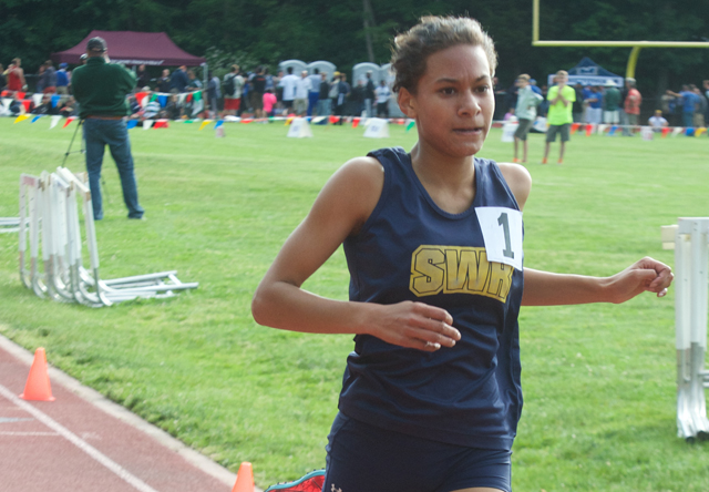 Shoreham-Wading River freshman Katherine Lee crosses the finish line of the 3,000 in first place Friday. (Credit: Robert O'Rourk)