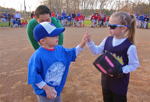 Jonas Wan hi-fives Emma Freeborn, who threw out the first softbal pitch Friday. (Credit: Barbaraellen Koch)