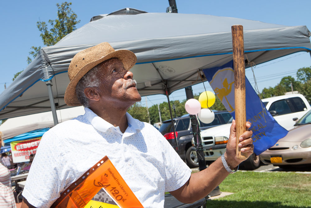 "Harry of Riverhead" tries out a rain stick from a display provided by the Southold Indian Museum. (Credit: Katharine Schroeder)