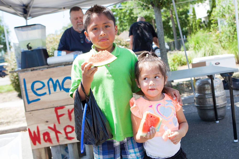 Ody Gochez, 8, and sister Rosie, 3, enjoy watermelon. (Credit: Katharine Schroeder)